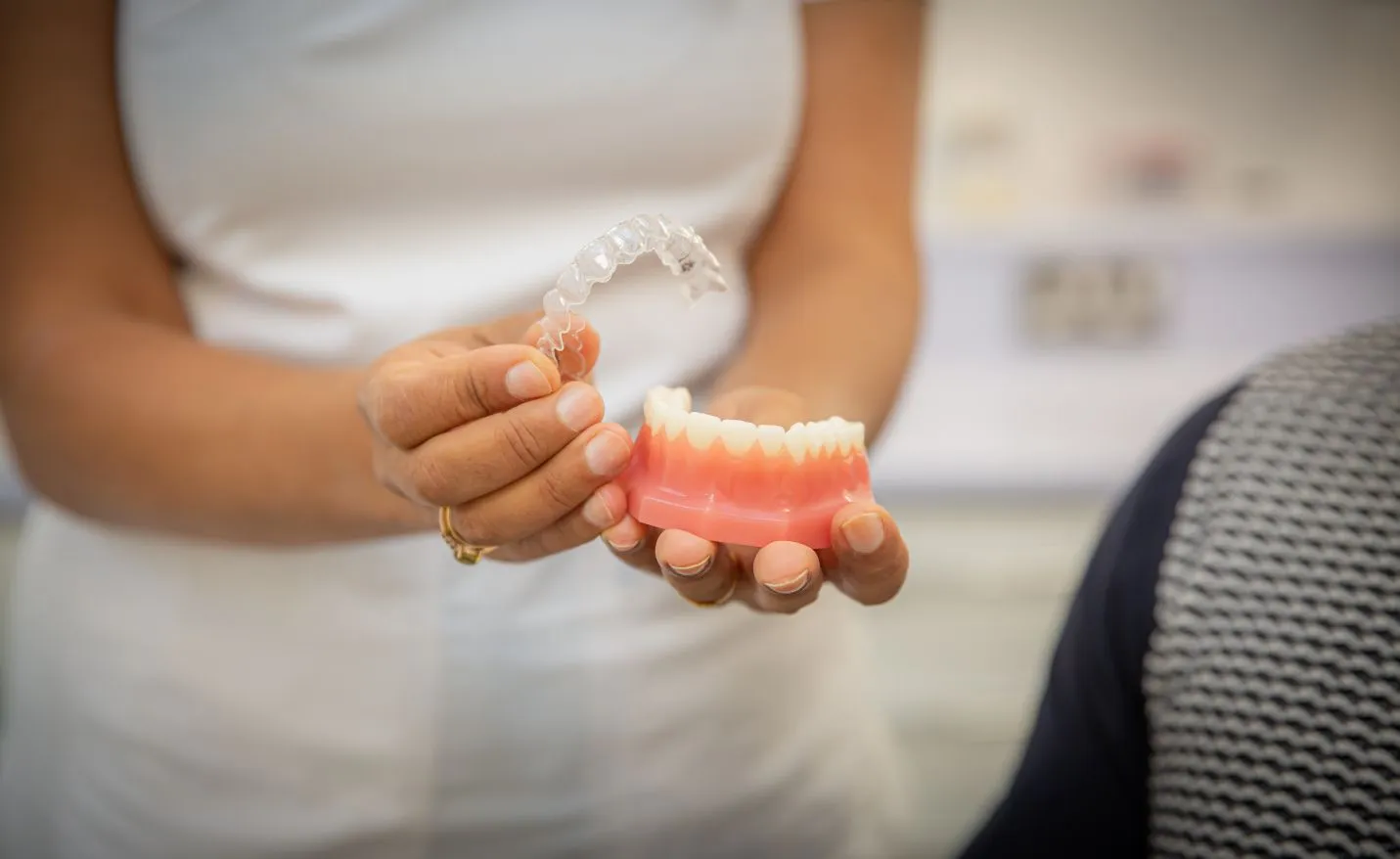 A clear aligner and dental mould held in hand