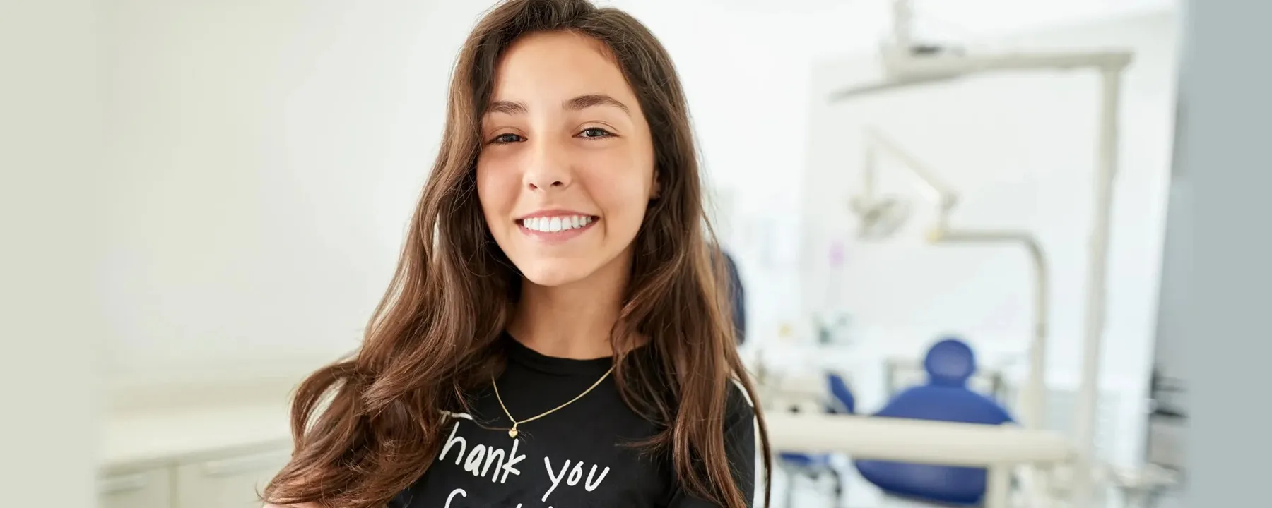 A smiling patient in the dental chair